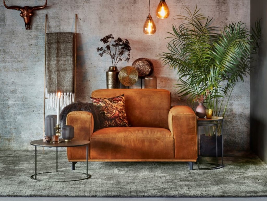 Brown loveseat with cushions and ceiling lights