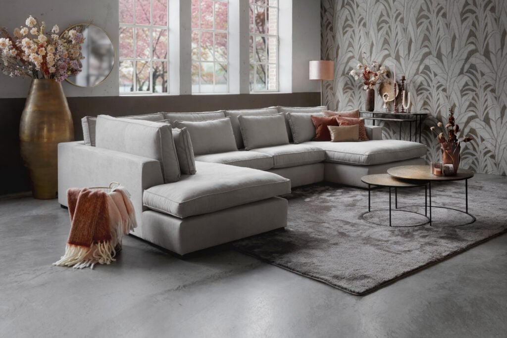 Light Annabelle Square corner sofa with round coffee tables, pink decoration and a large rug.