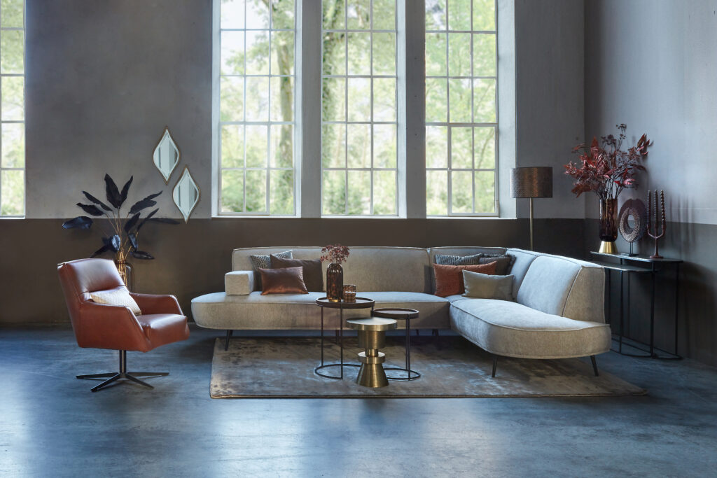 Beige corner sofa Arielle with round shapes and cognac leather armchair Tommy Smal.