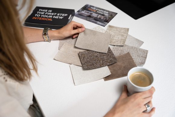 Diversi tessuti leggeri sul tavolo con una tazza di caffè