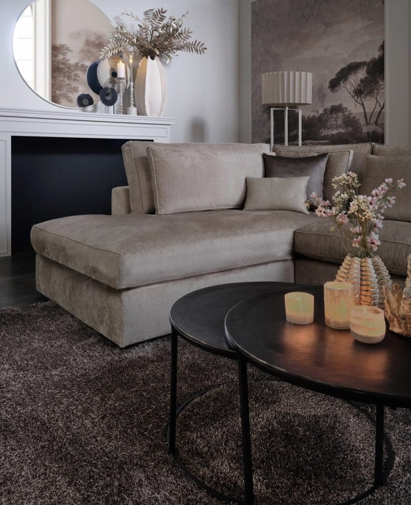 Beige corner sofa in luxurious interior and interior styling.