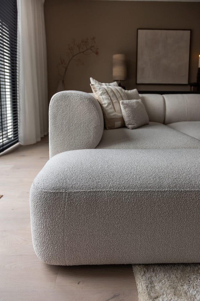 Beige corner sofa with round shapes in a Japandi interior. Inside look at Jenny.